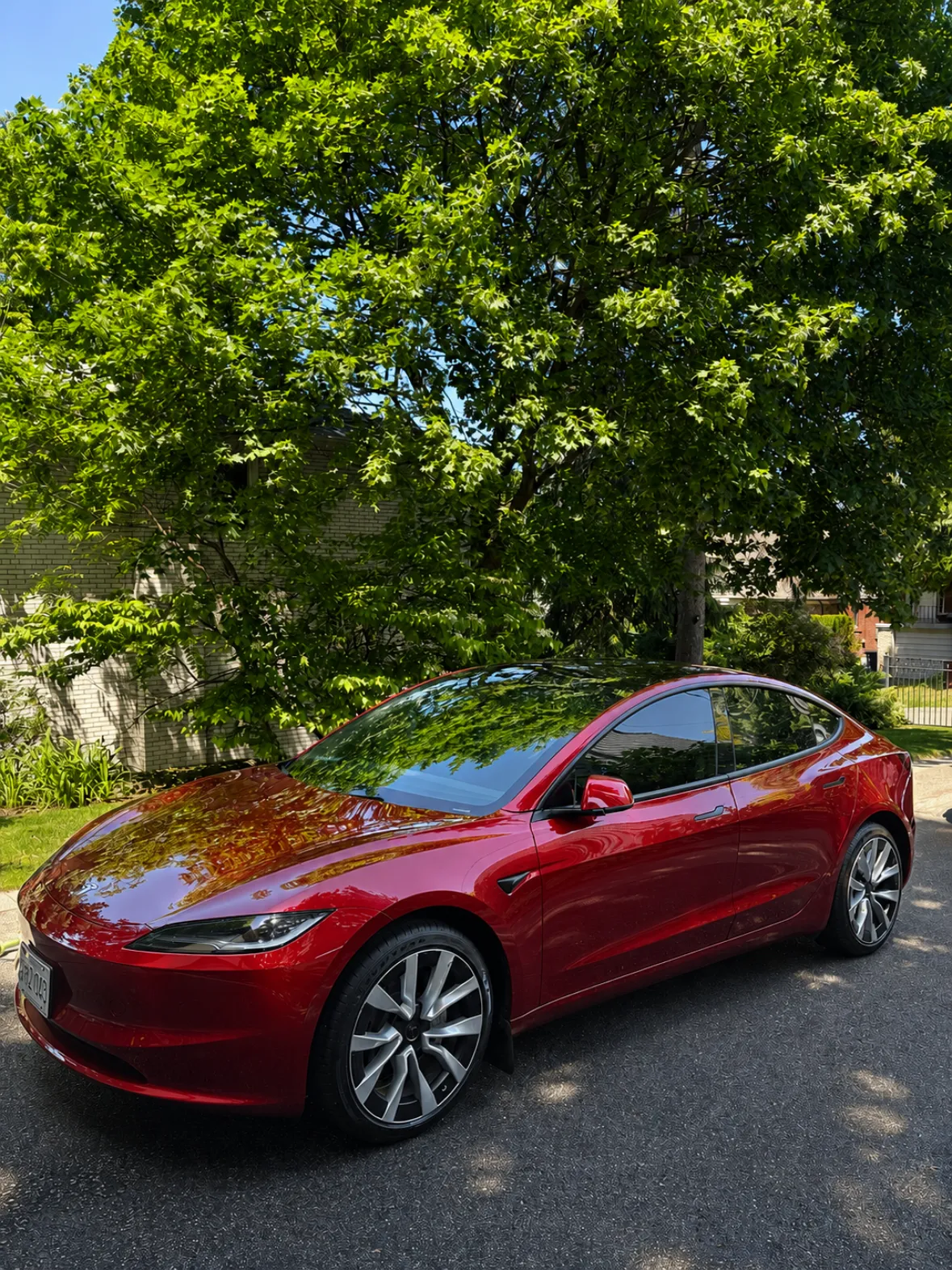 Tesla side panel with a clean, reflective finish after an exterior detail